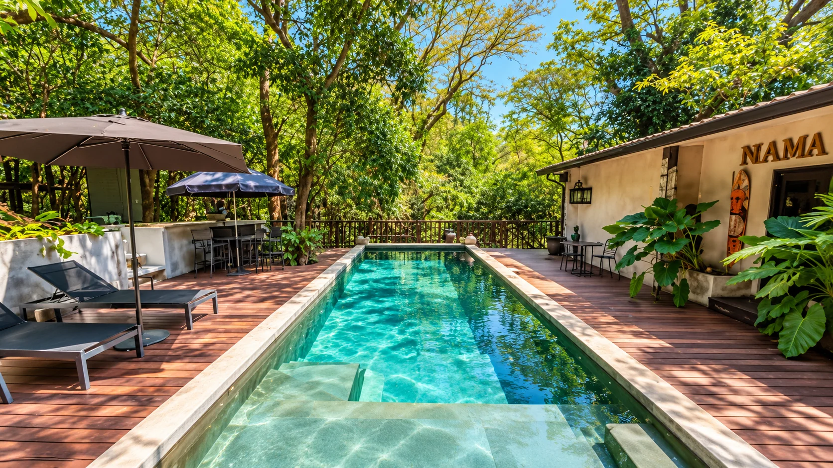 Saboga Lodge lap pool with wooden deck, lounge chairs and tropical trees, Saboga Island, Pearl Islands, Panama